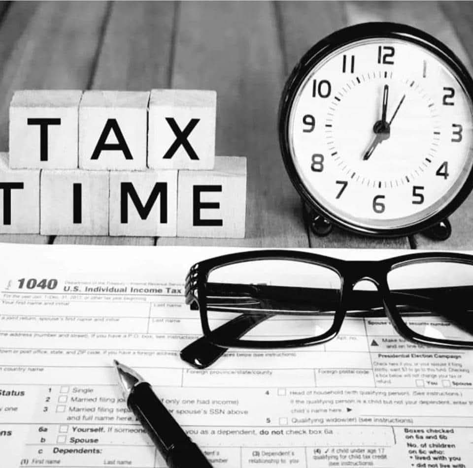 Tax Filing Services - Calculator and documents on desk